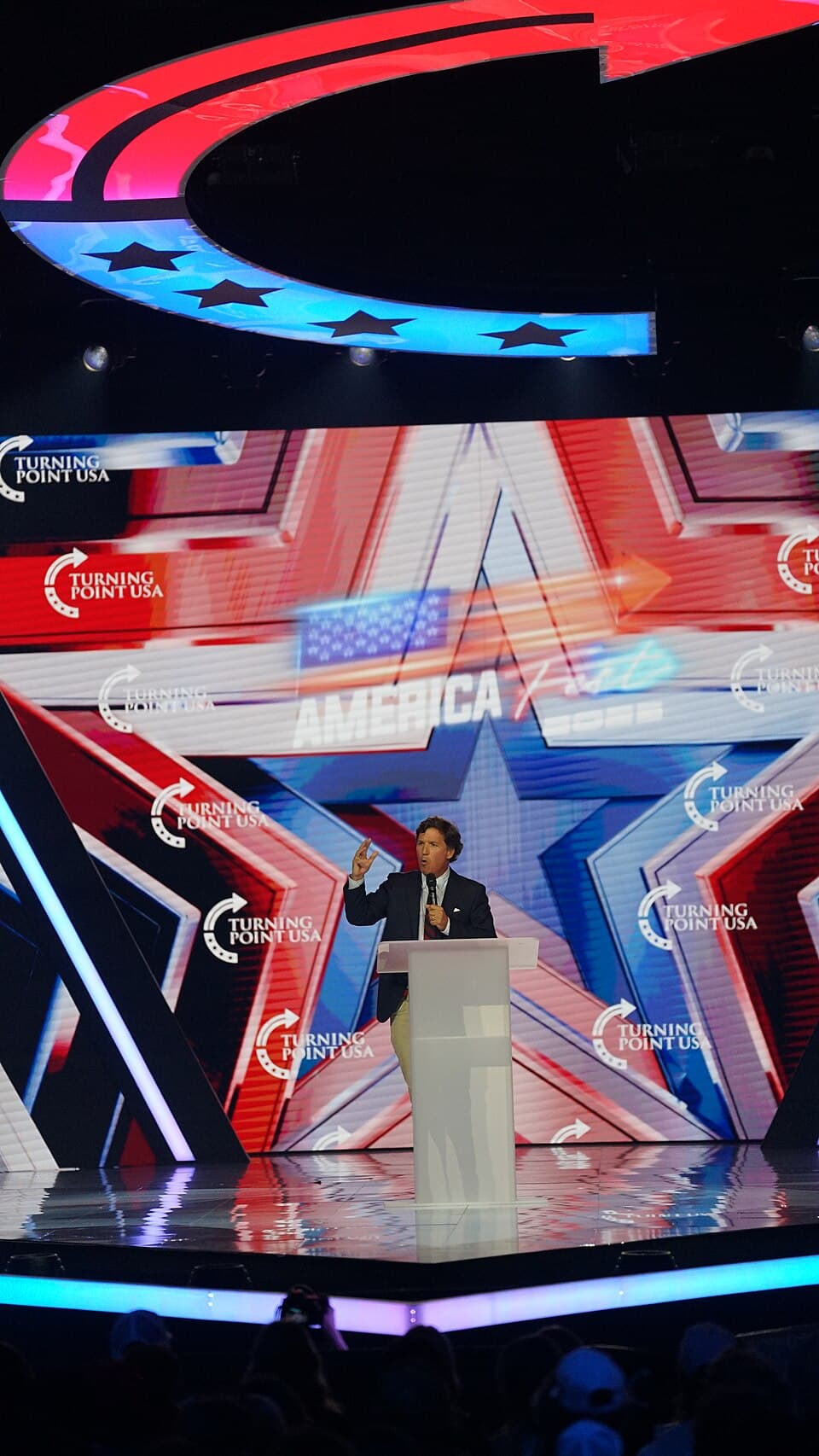 Tucker Carlson on stage at AmericaFest, December 2025.